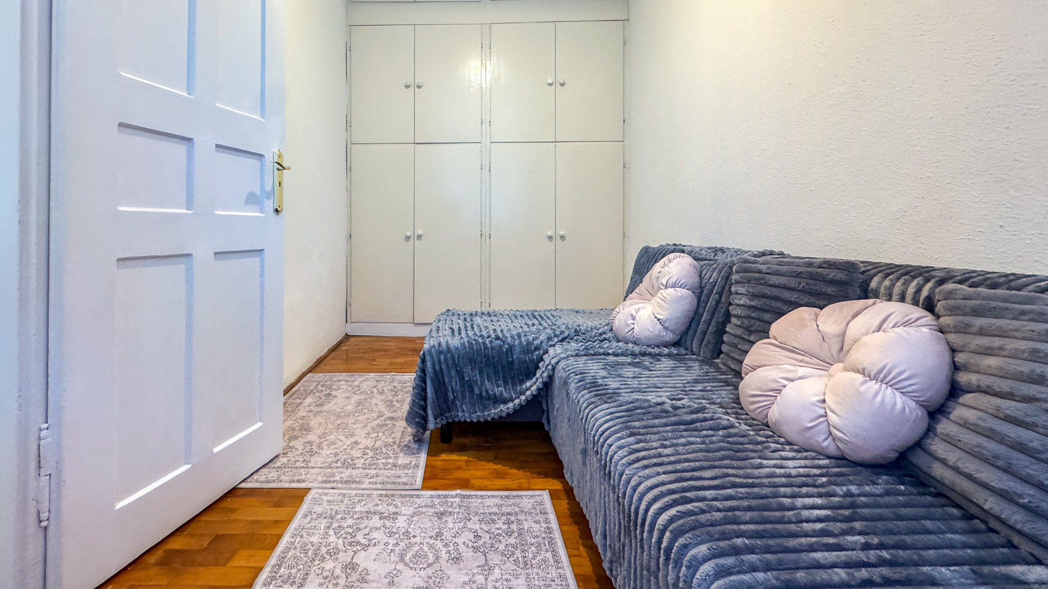 Room with sofa and built-in wardrobe, flat for rent near Blaha